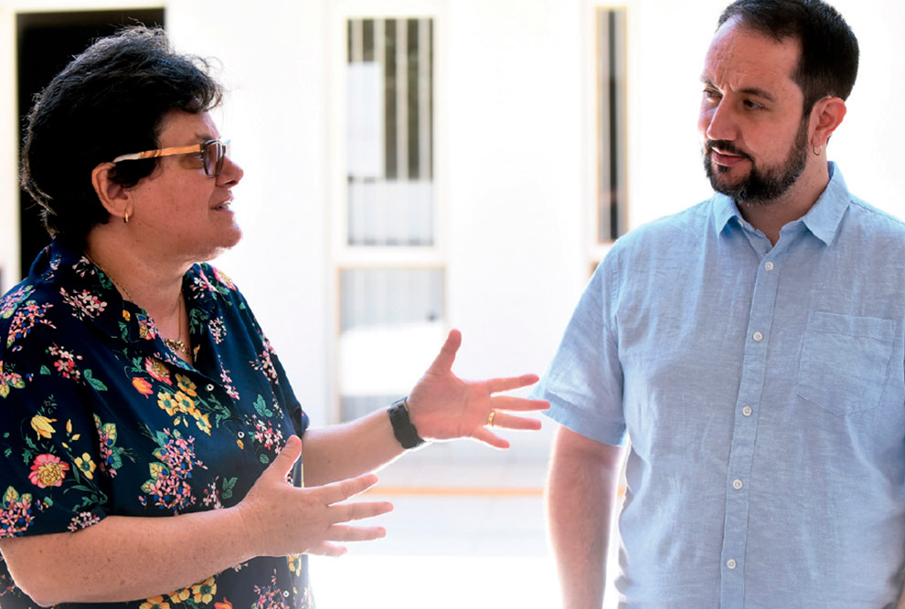 Foto de uma mulher (à esquerda) e um homem (à direita) conversando.