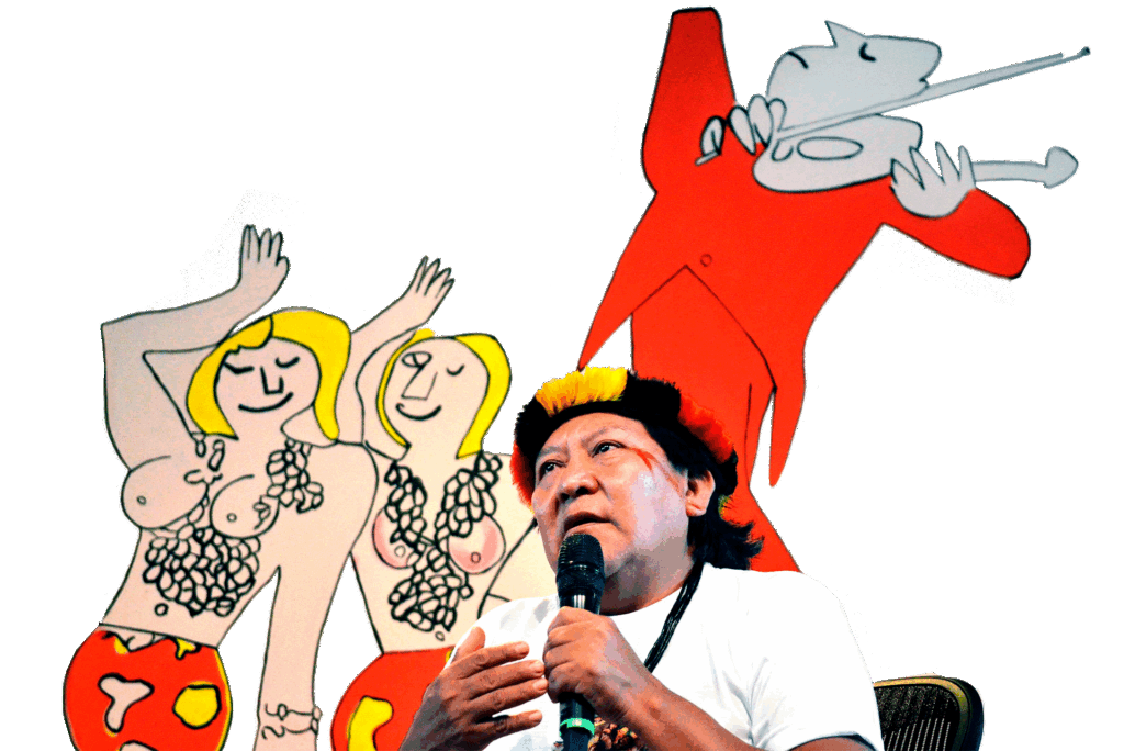A imagem retrata o renomado líder e xamã Yanomami, Davi Kopenawa, um dos principais porta-vozes dos povos indígenas do Brasil. Ele está em um evento, falando ao microfone com uma expressão concentrada. Kopenawa veste uma camiseta branca, um colar de contas escuras e seu tradicional cocar de penas pretas com uma faixa frontal em amarelo e vermelho.

O fundo da imagem é composto por um painel branco com uma grande ilustração de estilo moderno e cartunesco. A arte exibe, à esquerda, duas figuras femininas loiras e, à direita, uma figura estilizada de fraque vermelho tocando violino. A composição cria um forte contraste visual entre a presença de Kopenawa, representando a cultura e a luta Yanomami, e a obra de arte ocidentalizada ao fundo, possivelmente em um evento cultural ou político.